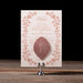 Heaton decorative menu card with floral design on a stand against a dark background
