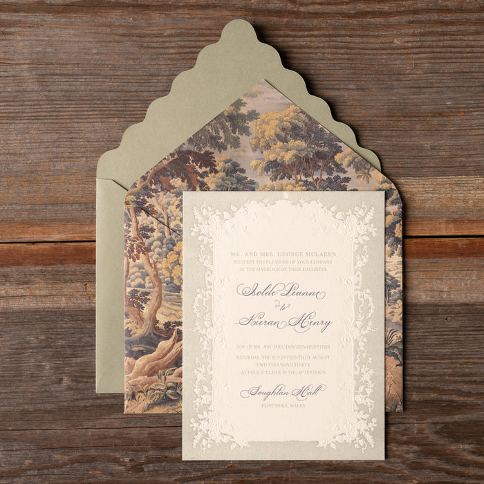 Decorative Isolde wedding invitation with floral patterned envelope on a wooden surface