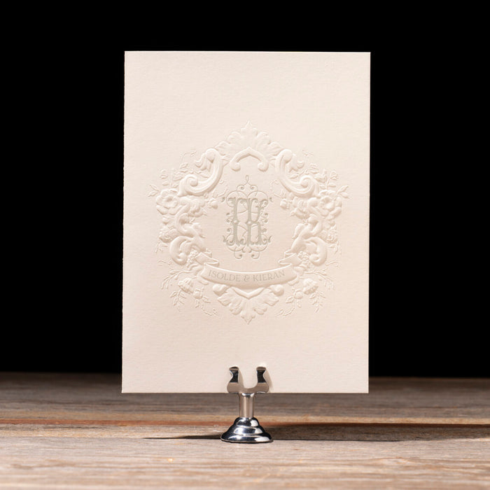 Decorative card with embossed design on a stand against a black background