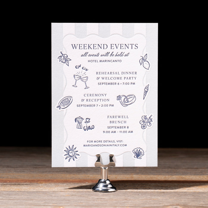Wedding event schedule card on a wooden surface with a black background