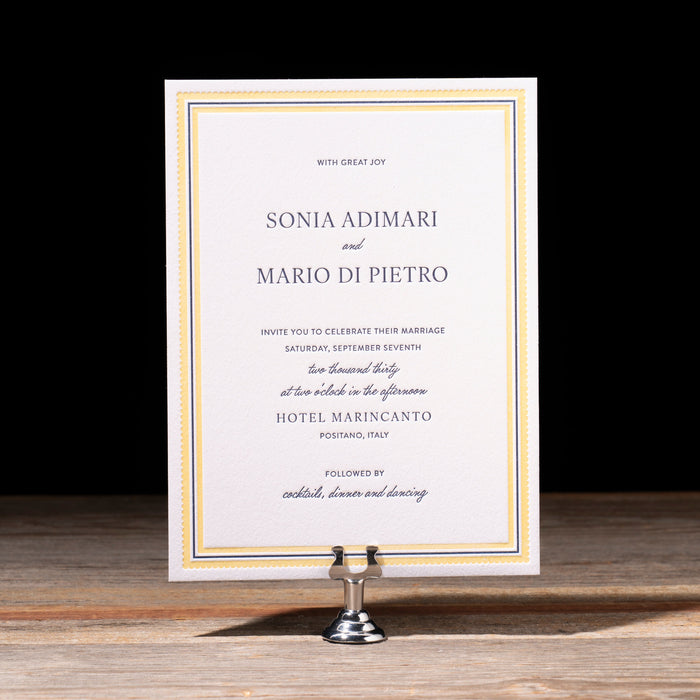 Italo wedding invitation card on a stand with a black background