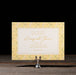 Wedding save the date card on a stand with a yellow floral border