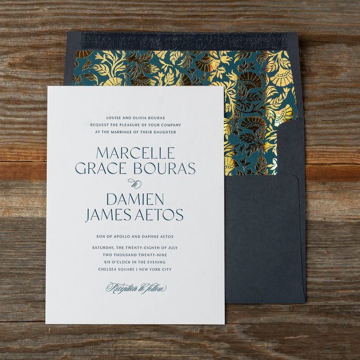 Marcelle wedding invitation card with decorative envelope on a wooden surface