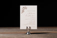 Invitation card on a stand with a dark background