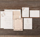Set of wedding invitations on a wooden surface