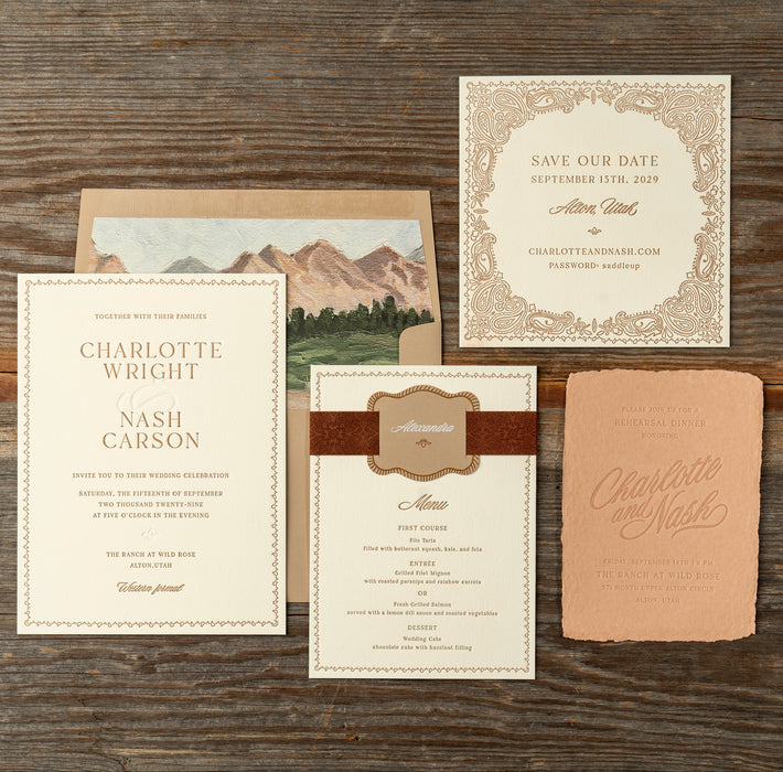 Nash wedding invitation suite and save the date card on a wooden surface