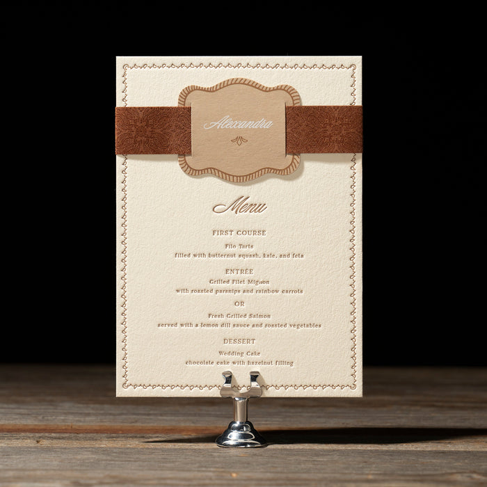 Nash menu card with decorative band on a stand against a dark background