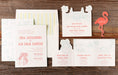 Wedding invitation set with different card and decorative elements on a wooden surface