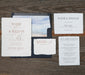 Set of wedding invitations on a wooden surface