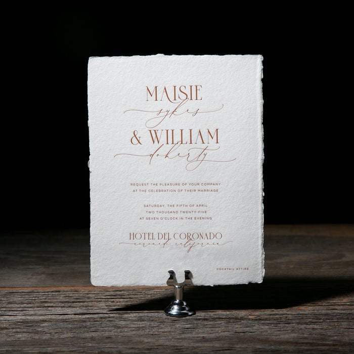 Wedding invitation card on a stand with a dark background