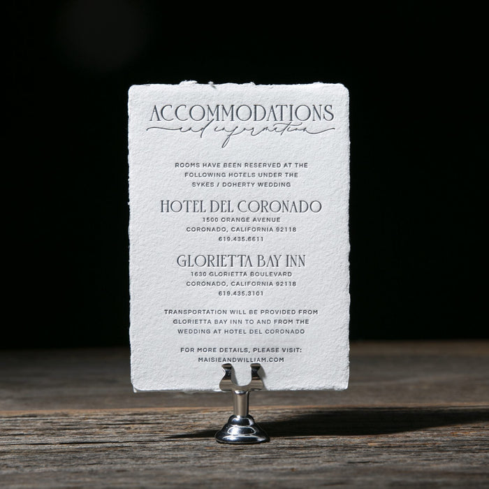 Accommodations information card on a stand with a dark background