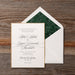 Rhea Wedding invitation card with green envelope liner on a wooden surface
