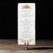 Rhea Dinner menu on a stand with a dark background