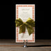 Royce menu card with a green bow on a stand against a black background