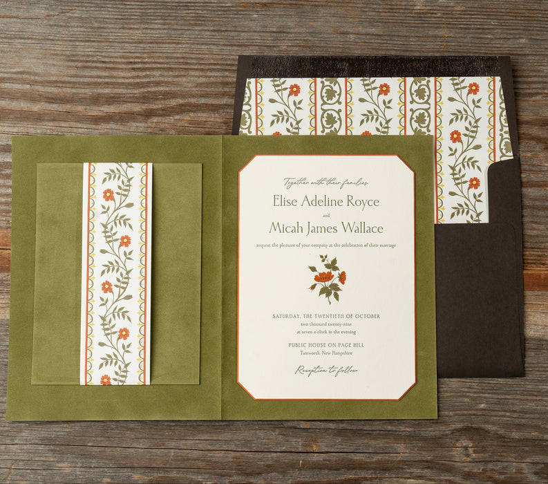 Royce Invitation card with floral design on a wooden surface