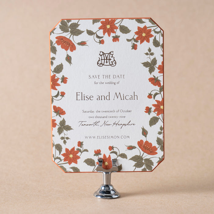 Floral Royce save the date card on a stand with a beige background