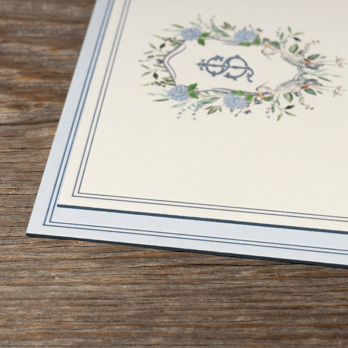 Ryann wedding invitation  'Save the Date' card detail showing edgepainting on a wooden surface