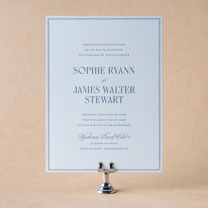 Ryann v2 wedding invitation card on a stand with a beige background