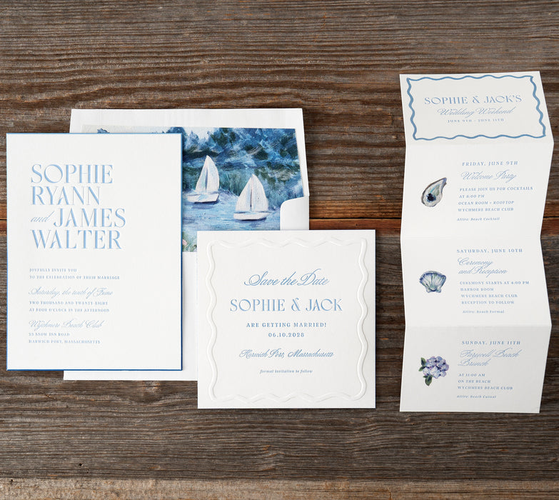 Ryann suite of wedding invitations with nautical theme on a wooden surface