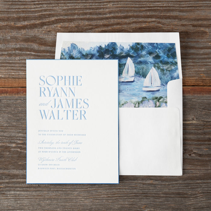 Ryann wedding invitation card with envelope on a wooden surface