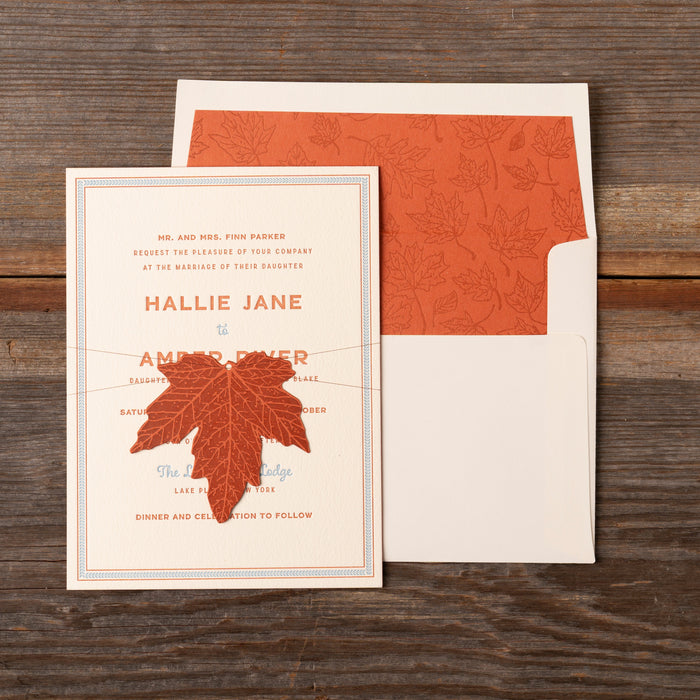 Scout Invitation card with red maple leaf design on a wooden surface