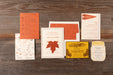 Collection of vintage-style stationery from Scout suite on a wooden surface