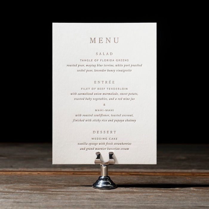 Sedna Menu card with text on a stand against a dark background