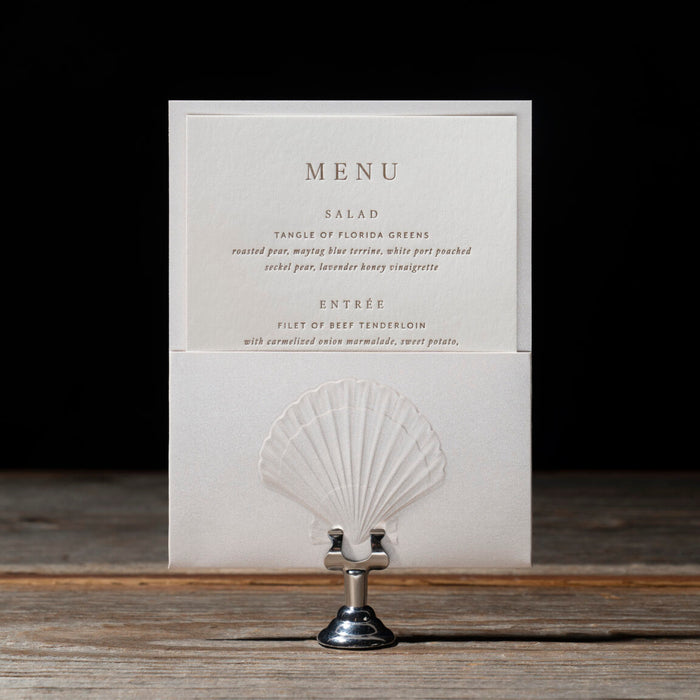 Sedna Menu card with shell design holder on a wooden surface