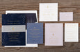 Collection of wedding invitation cards on a wooden surface