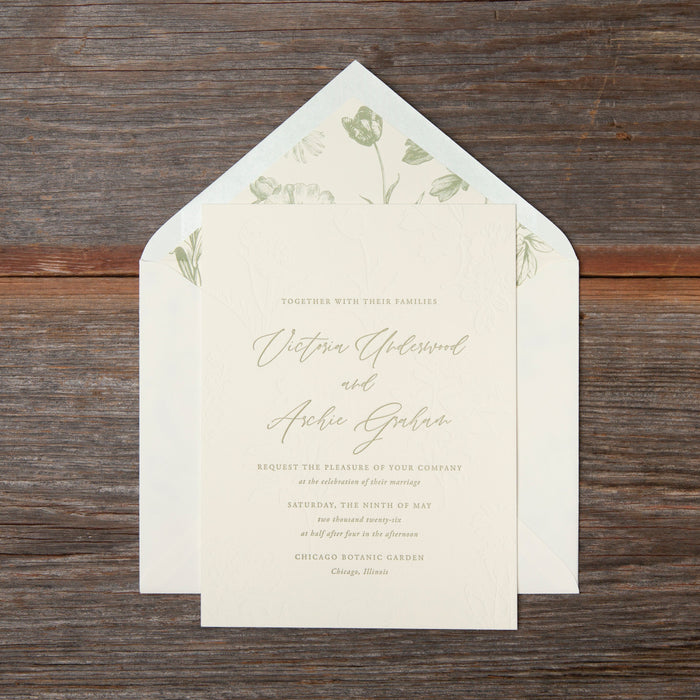 Wedding invitation card with floral design on wooden surface