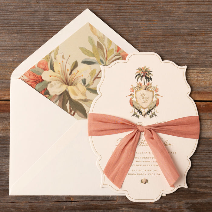 Decorative Yasmin wedding invitation with a ribbon on a wooden surface