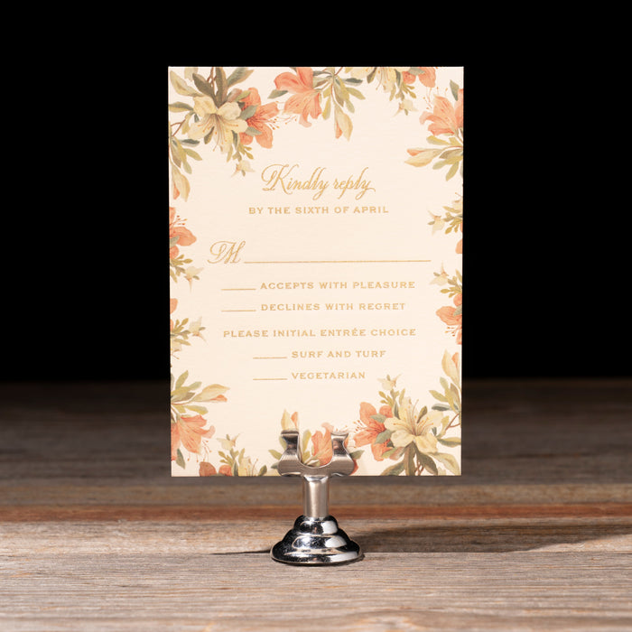 Floral reply card on a stand with a dark background