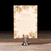 Floral reply card on a stand with a dark background